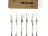 six forks in a box with a box of forks in the background