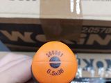 a person holding an orange ball in front of a stack of boxes