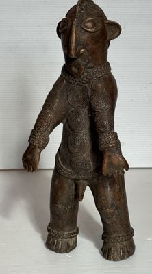 une petite statue représentant un ours coiffé d'un chapeau