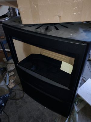 a black stove with a cardboard box on top of it