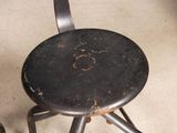 two black stools sitting next to each other on the floor