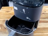 a coffee maker sitting on top of a wooden table