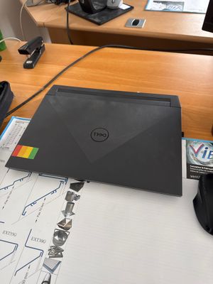 a laptop computer sitting on a desk in front of a computer monitor