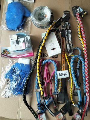 a lot of dog leashes that are on a cardboard box