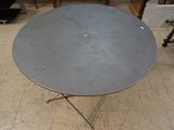 une image représentant une table avec un plateau circulaire en métal