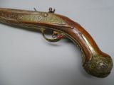 a close up of a gun on a table with a white background