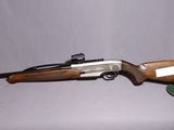 an old gun with a wooden barrel and a leather case