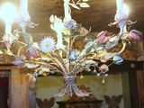 a chandelier with a bunch of flowers hanging from it