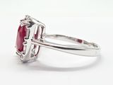 an oval ruby and diamond ring set in white gold