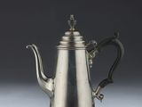silver plated coffee pot with a handle and a handle