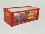 a red toy car in a clear box on a white surface