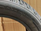 a close up of a tire on a cardboard box with a cardboard box in the background