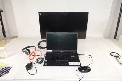a laptop computer sitting on top of a white table