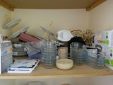 a wooden shelf with a lot of dishes and bowls on it