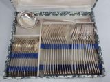 a box of silverware with blue handles and spoons in it