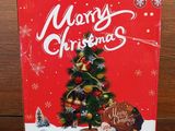 a red box with a christmas tree on it sitting on a table