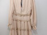 the dress is hanging on a hanger on the wall