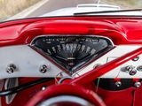 a red and white car dashboard with a speedometer in it