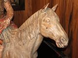 a statue of a woman riding a horse in a room