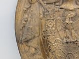 an image of a gold plate with a coat of arms on it