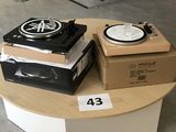 une table sur laquelle se trouvent un tourne-disque et une boîte