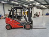 a red fork truck parked in a warehouse