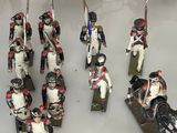 many figurines of soldiers on display in a glass case