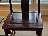 a wooden chair that is sitting in front of a window