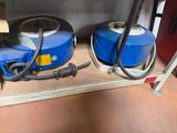 two blue drums sitting on a shelf next to each other