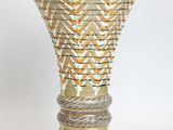 an image of a vase with a woven design on it