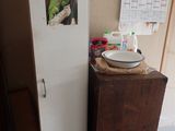a refrigerator with a bowl on top of it in a kitchen