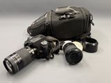 two cameras and a camera bag on the table