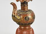 an image of a decorative vase with a bird on top of it