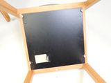 a small blackboard on a wooden stand on a white surface