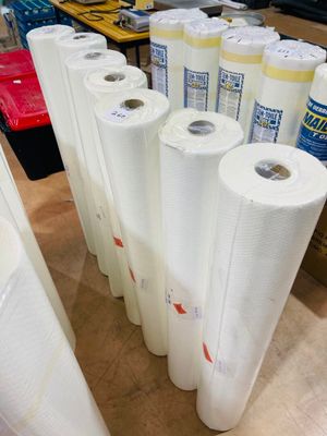 many rolls of white paper on a table in a room