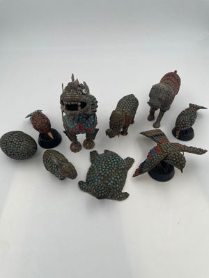 a lot of figurines that are sitting on a table
