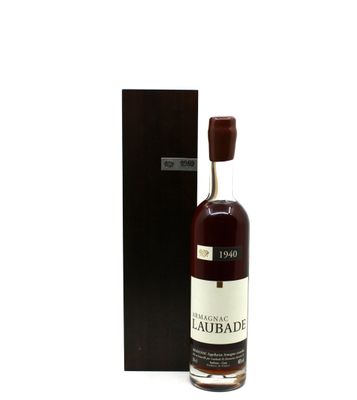 the bottle of whisky is next to the box on the table