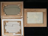 three wooden frames with pictures in them on a black surface