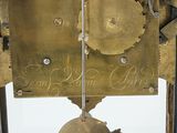 a clock that has a bell on the side of it