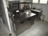 a large stainless steel kitchen with a sink and a stove