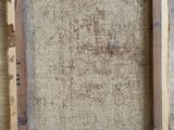 an old picture frame is hanging on a wooden wall