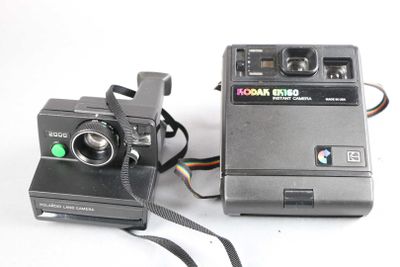 a polaroid camera next to a polaroid camera on a white surface