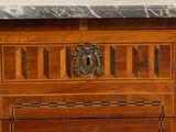 a close up of a wooden dresser with a marble top