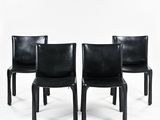 three black leather chairs with black legs and a white background