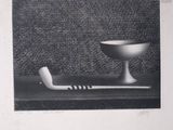 black and white photograph of a bowl and a pipe on a table