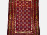 a red rug with a floral design on a white background