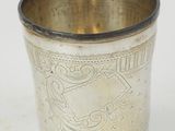 a silver cup that is sitting on a table