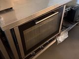 a silver counter top with a silver oven on it