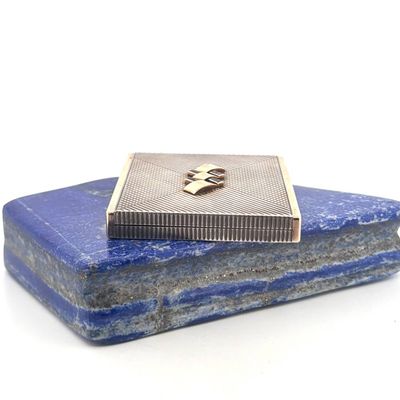 a blue stone with a silver metal box on top of it