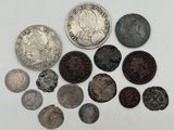 several different types of coins are shown on a white surface